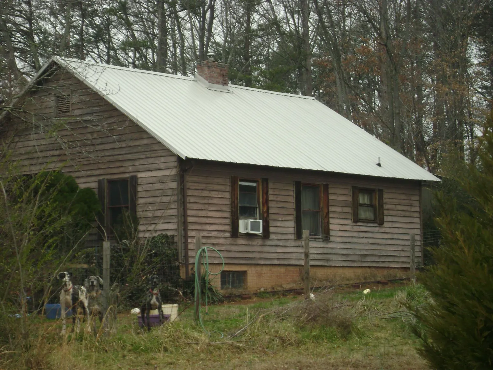 White metal roof on an old wood sided farmhouse, from a Metal Roof Installation job in Kennard